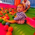 Photograph, Yellow, Leisure, Red, Fun, Aire de jeux, Bambin, Sourire, Recreation, Enfant, Plante, Happy, Ball Pit, Baby, Chute, Play, Party Supply, Outdoor Play Equipment, Baby & Toddler Clothing, Personne, Joy, Headwear