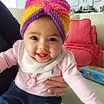 Clothing, Nez, Joue, Sourire, Peau, Head, Lip, Chin, Eyebrow, Yeux, Cap, Mouth, Purple, Human Body, Textile, Sleeve, Happy, Baby, Baby & Toddler Clothing, Rose, Personne, Joy, Headwear