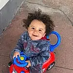 Clothing, Sourire, Head, Shoe, Facial Expression, Baby & Toddler Clothing, Happy, Red, Bambin, Fun, Electric Blue, Enfant, Baby, Road Surface, Assis, Leisure, Play, Concrete, Asphalt, Personne, Joy