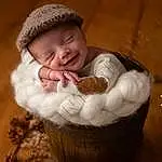 Joue, Comfort, Sourire, Bois, Basket, Baby, Bambin, Baby & Toddler Clothing, Arbre, Wool, Assis, Woolen, Wicker, Poil, Enfant, Sweetness, Happy, Knitting, Baby Sleeping, Portrait Photography, Personne, Joy, Headwear