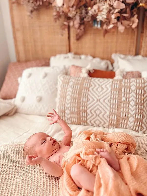 Hand, Photograph, Blanc, Comfort, Textile, Plante, Dress, Rose, Baby & Toddler Clothing, Baby, Chair, Bois, Linens, Peach, Bambin, Pattern, Room, Bedding, Human Leg, Personne
