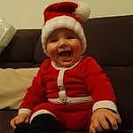 Sourire, Yeux, Facial Expression, Baby, Human Body, Comfort, Happy, Baby & Toddler Clothing, Sleeve, Santa Claus, Finger, Bambin, Lap, Chapi Chapo, Costume Hat, Cap, Assis, Event, Fictional Character, Personne, Headwear
