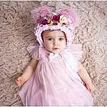 Clothing, Dress, Baby & Toddler Clothing, Sleeve, Rose, Happy, Embellishment, Bambin, Petal, Flash Photography, Baby, Day Dress, Headpiece, Headband, Magenta, Pattern, Enfant, Costume Hat, Fashion Accessory, Linens, Personne, Headwear